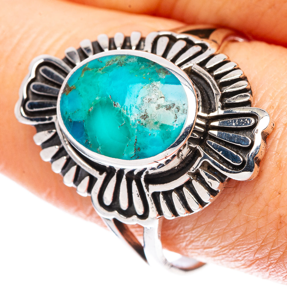 Turquoise oval ring on finger, silver scalloped bezel with eye-catching side details
