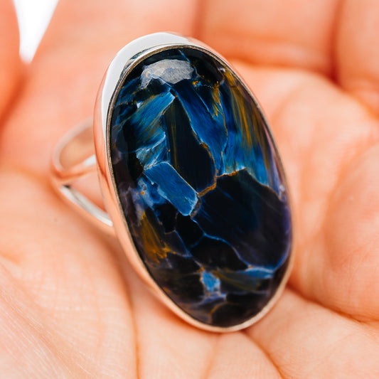 Oval blue pietersite ring with silver bezel and curved band, dark stone streaks