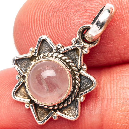 Rose quartz pendant: oval pink cabochon in sterling silver starburst setting
