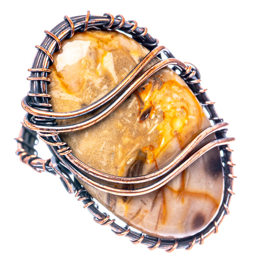 Oxidized copper wire wrap ring with two oval amber-stone cabochons in stacked dark wire coils