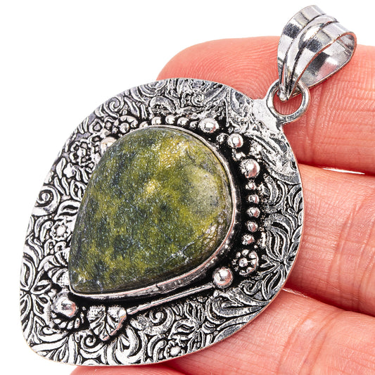 German silver teardrop pendant with yellow-green stone and decorative filigree bezel