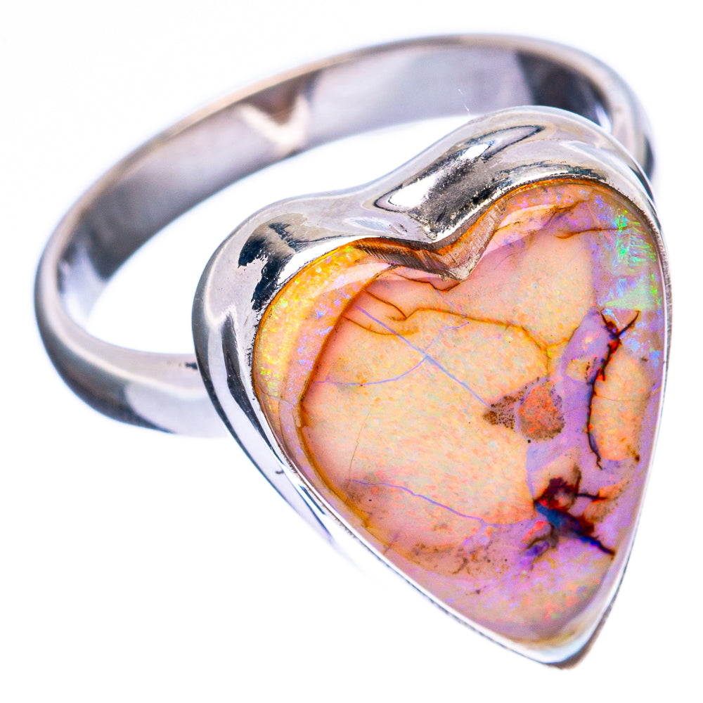 Heart-shaped opal in sterling silver ring, close-up of colorful iridescent stone