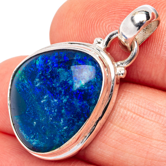 Sterling silver opal pendant with teardrop blue gemstone in bezel, close-up