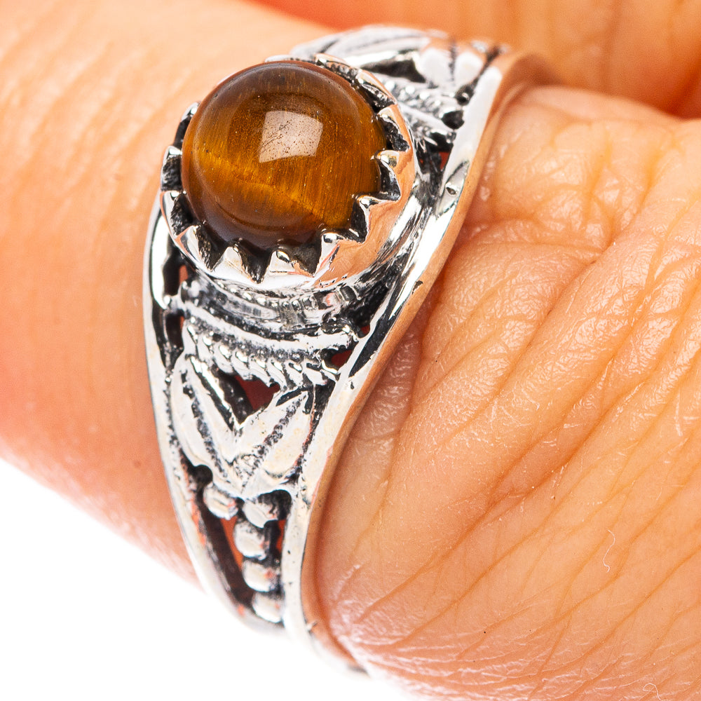 Sterling silver ring close-up with amber tiger eye stone and detailed engraved side
