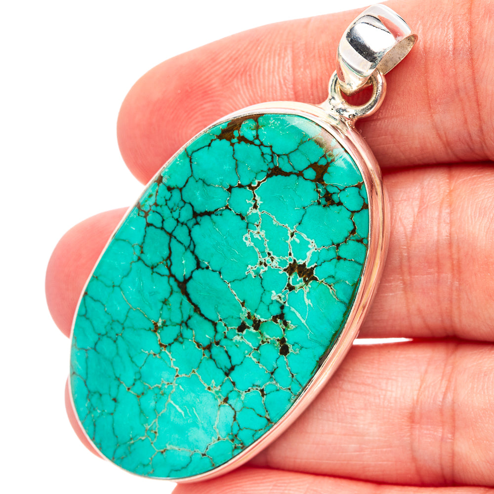 Oval turquoise pendant with sterling silver bezel and bail, patterned stone detail
