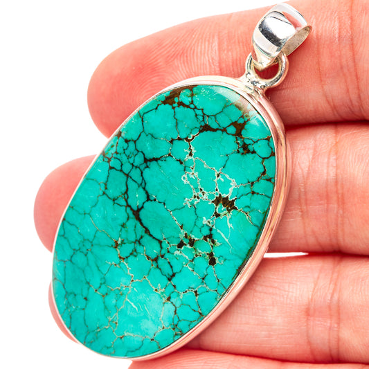 Oval turquoise pendant with sterling silver bezel and bail, patterned stone detail