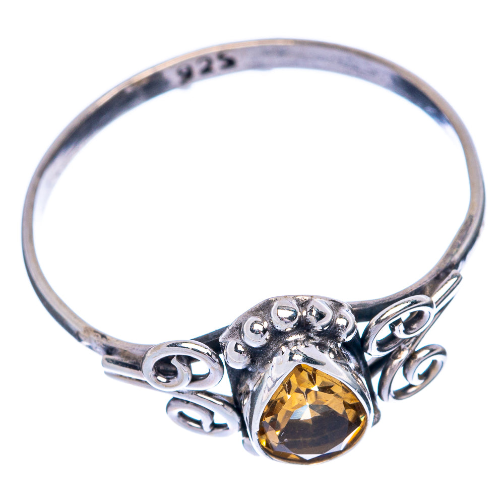 Sterling silver ring band with faceted yellow citrine and swirling openwork bezel