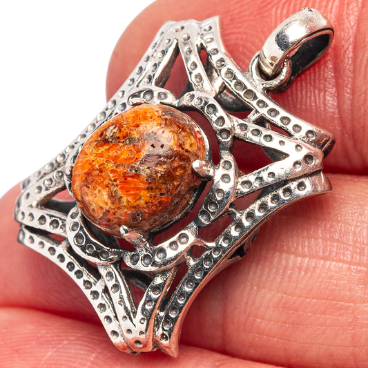 Sterling silver coral pendant with oval orange sponge coral cabochon and ornate bezel frame