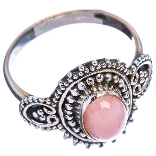 Sterling silver ring with pink opal setting and decorative swirl bezel, size 7.5