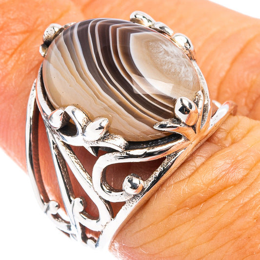 Sterling silver ring with oval Botswana agate cabochon and ornate bezel setting