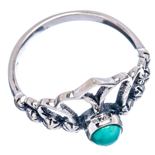 Sterling silver dainty ring with crown-like openwork and turquoise oval gemstone.
