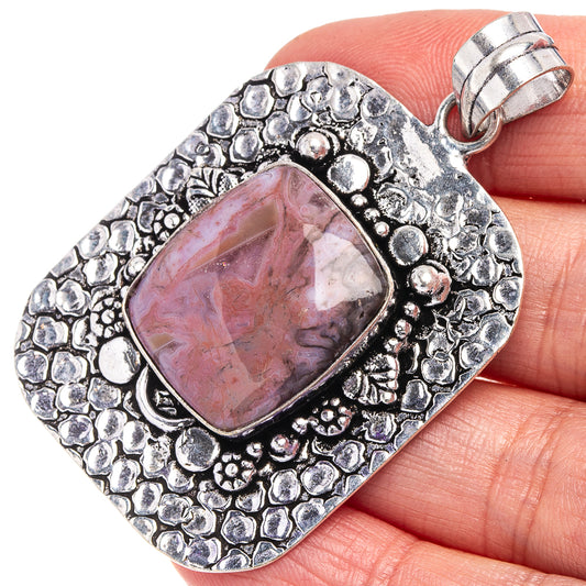 Ocean jasper pendant in German silver, oval pink gemstone bezel with textured border