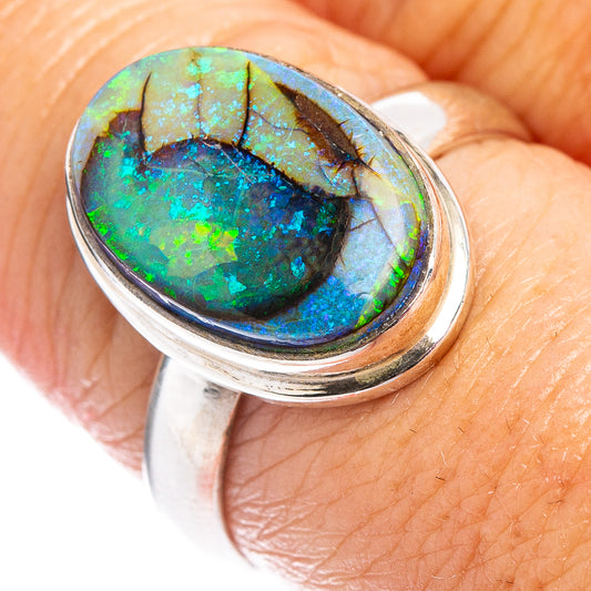 Oval opal set in .925 sterling silver bezel ring, dark blue-green fire