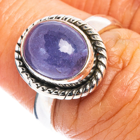 Sterling silver tanzanite ring with oval purple gemstone and ornate bezel detail