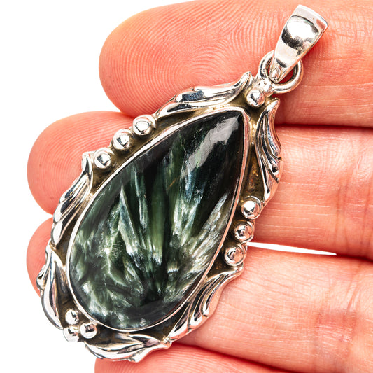 .925 sterling silver pendant with teardrop green seraphinite gemstone in ornate bezel setting