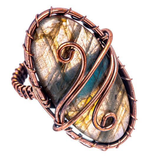 Oxidized copper wire-wrapped labradorite oval ring with yellow-blue metallic shimmer