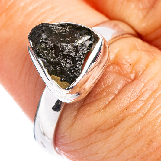 Moldavite ring in .925 sterling silver with rough dark green gemstone on band.