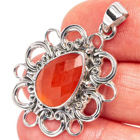 Oval red carnelian pendant with ornate sterling silver filigree and loop bail