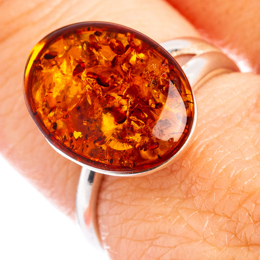 Round amber cabochon set on .925 sterling silver adjustable ring band