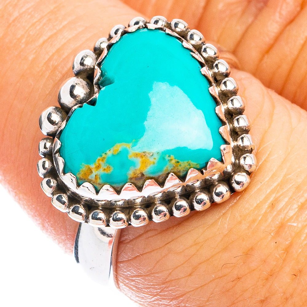 Heart-shaped turquoise ring with sterling silver beaded bezel on a hand