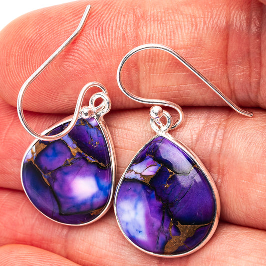 Close-up of purple-blue teardrop turquoise cabochon sterling silver hook earrings