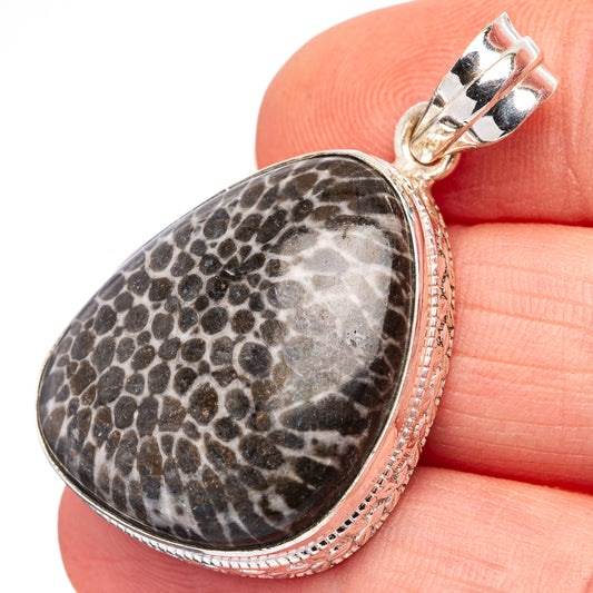 Sterling silver pendant with oval mottled gray-black stone and hinged bail