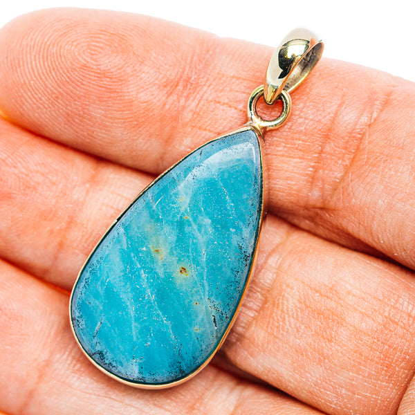 Blue teardrop opal pendant with gold-toned bail and German silver frame