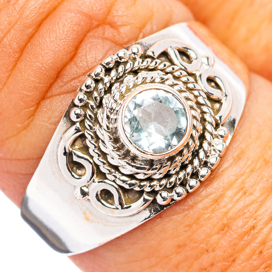 Sterling silver ring with oval blue topaz and ornate filigree setting