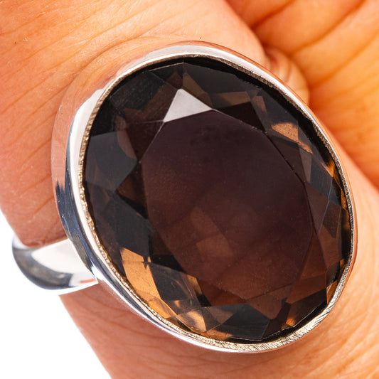 Sterling silver ring with oval faceted smoky dark gemstone in bezel setting