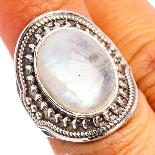 Oval moonstone ring in .925 sterling silver with ornate bezel setting and halo