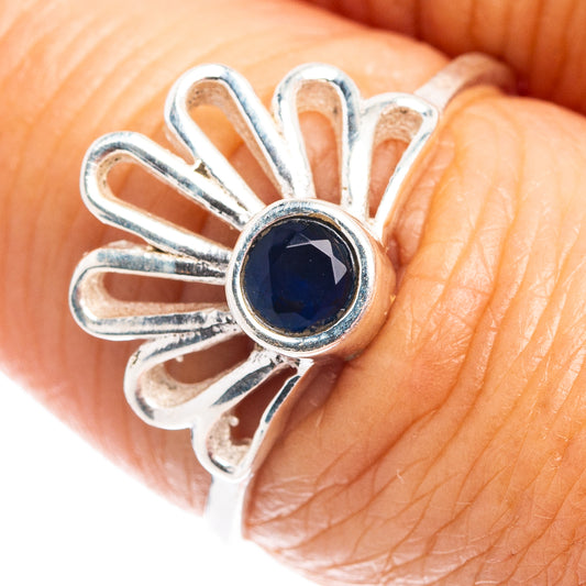 Sterling silver daisy ring with round dark-blue gemstone in open flower setting