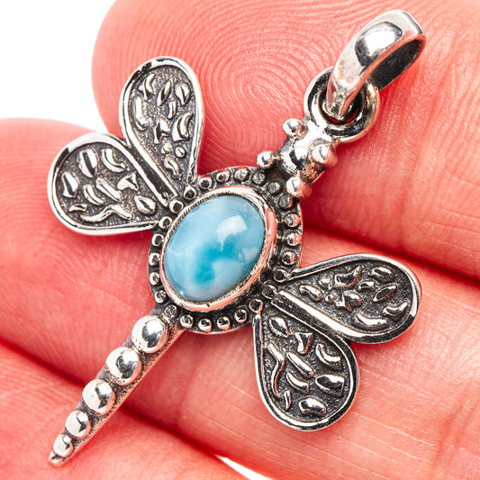 Dragonfly pendant in .925 sterling silver with oval blue Larimar cabochon and textured wings