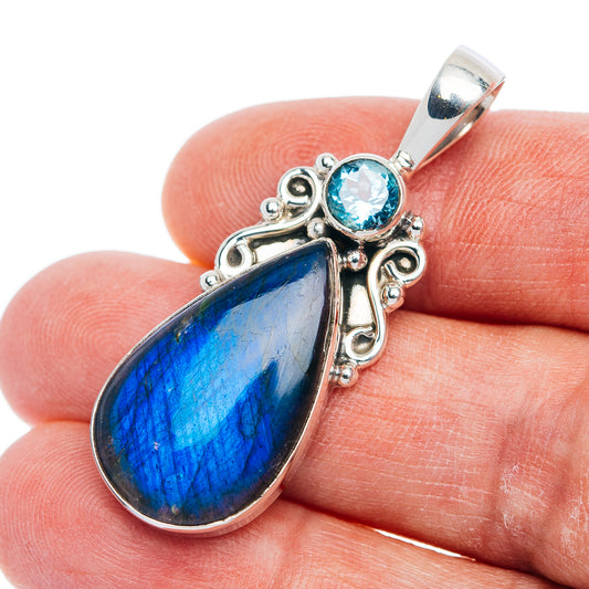 Sterling silver pendant with teardrop blue labradorite and round blue topaz accents