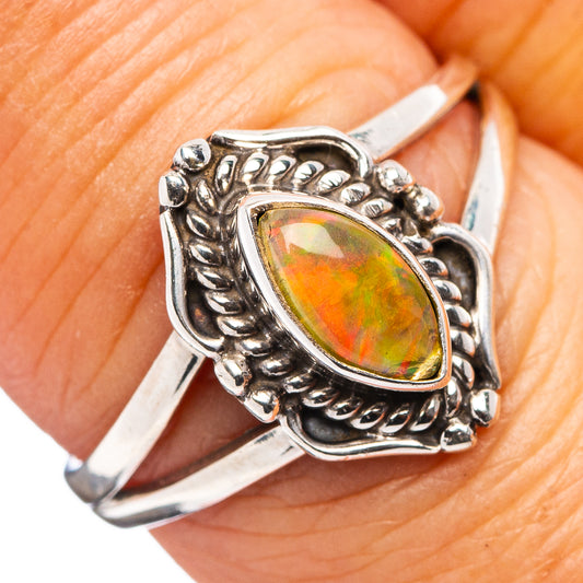 Sterling silver oval opal ring with ornate setting and green-orange center stone