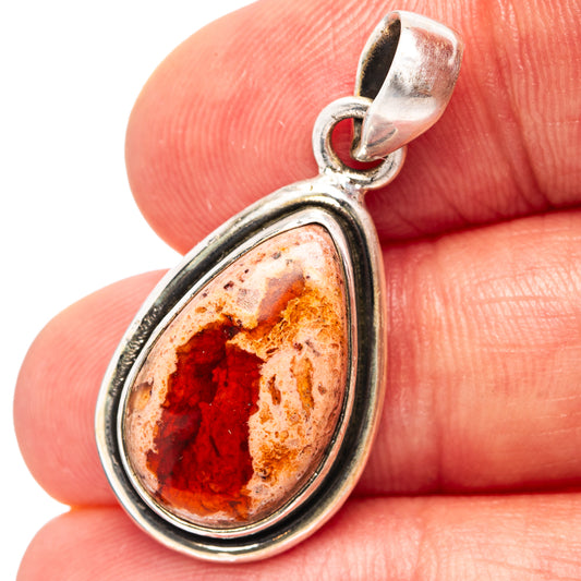 Sterling silver fire opal pendant with pear-shaped red-orange stone and textured frame