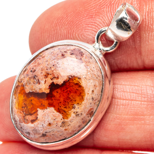Oval fire opal pendant in .925 sterling silver bezel, close-up of cabochon