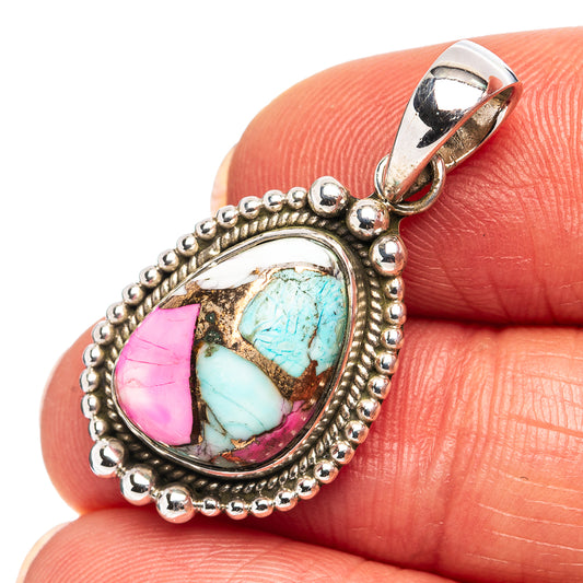 Sterling silver pendant close-up with turquoise and pink cabochon stone bezel