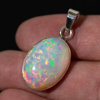 Oval opal pendant in .925 sterling silver with iridescent multicolor shimmer