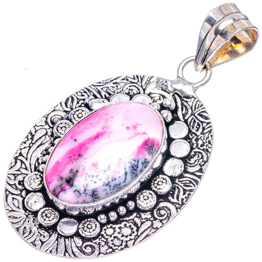 Dendritic opal pendant with oval pink dendritic stone and engraved silver-tone border, bail
