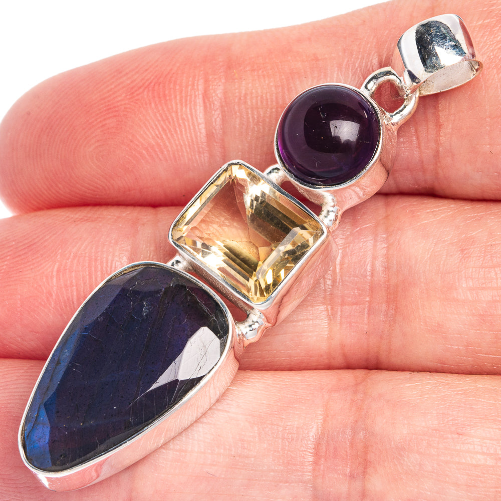 Sterling silver gemstone pendant close-up: purple round, yellow faceted square, dark blue oval