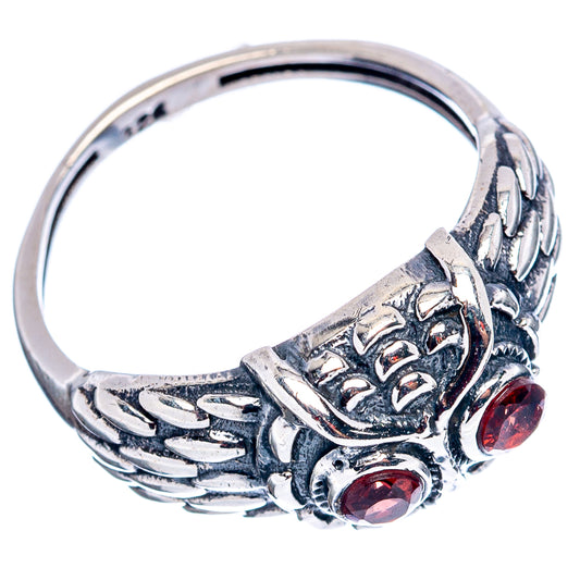 Sterling silver owl ring side view with red gemstone accents and raised band