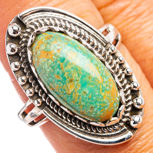 Turquoise oval stone sterling silver ring with rope-style bezel and ornate side details