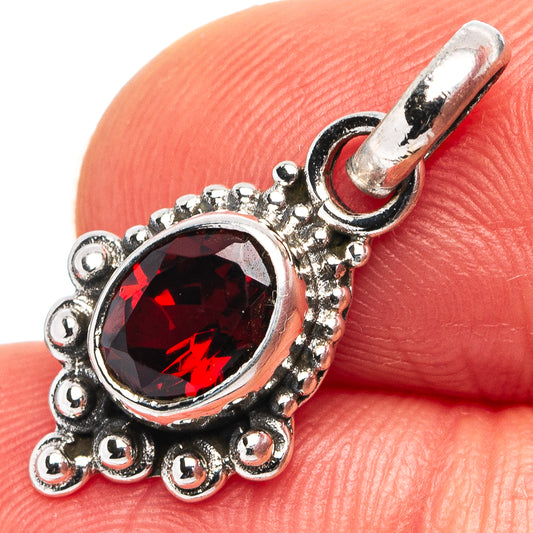 Garnet red oval pendant in .925 sterling silver filigree setting, bail loop on top
