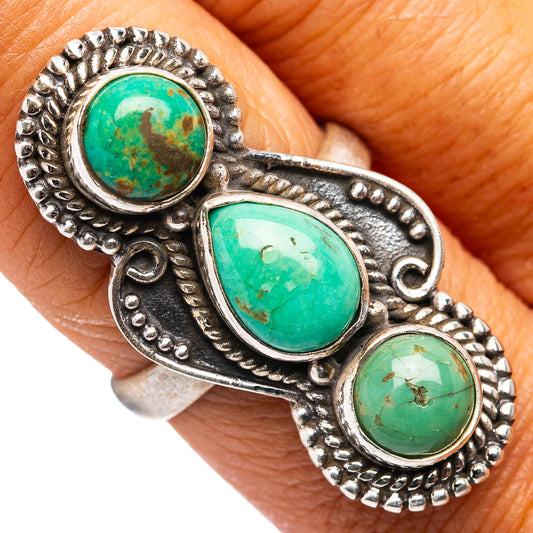 Turquoise cabochon triple-stone sterling silver ring on hand, ornate beaded setting