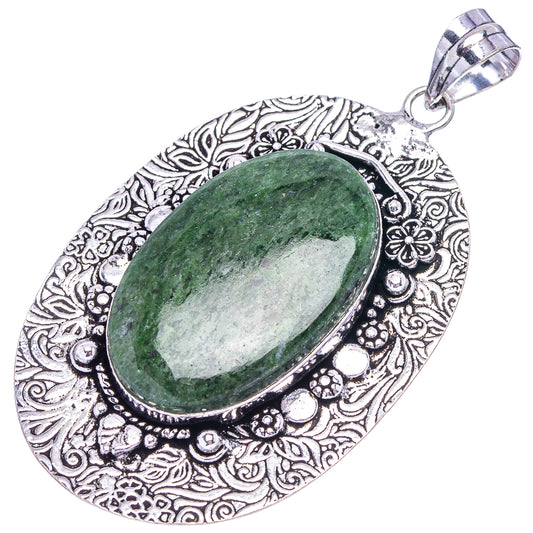 German silver pendant featuring oval green stone set in detailed floral filigree frame
