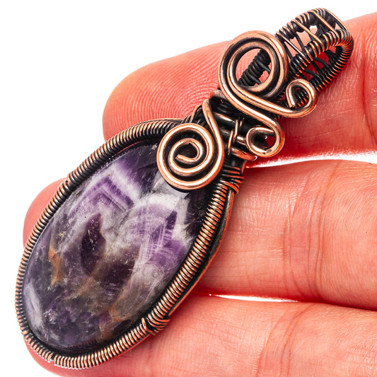 Amethyst wire wrap pendant with oxidized copper coiled bezel and swirl details