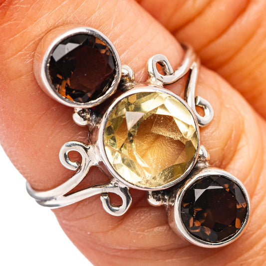 Sterling silver ring with round yellow quartz center and two dark bezel-set stones