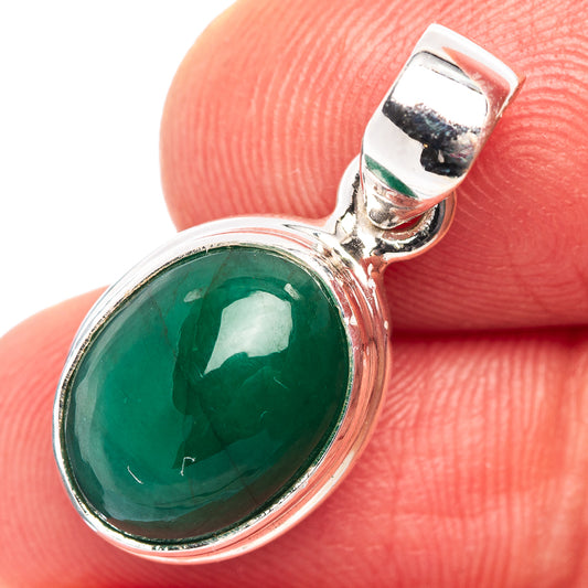Sterling silver oval green emerald pendant with round halo bezel, close-up