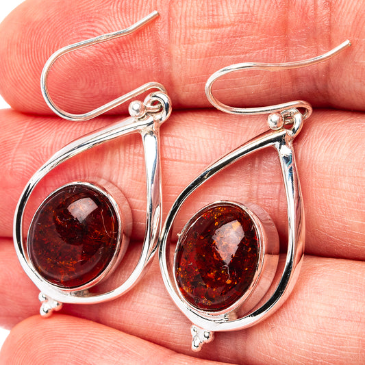 Sterling silver teardrop amber earrings with round red-brown amber cabochons