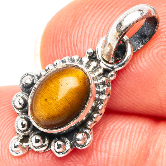 Sterling silver tiger's eye pendant with ornate oval bezel, golden-brown stone